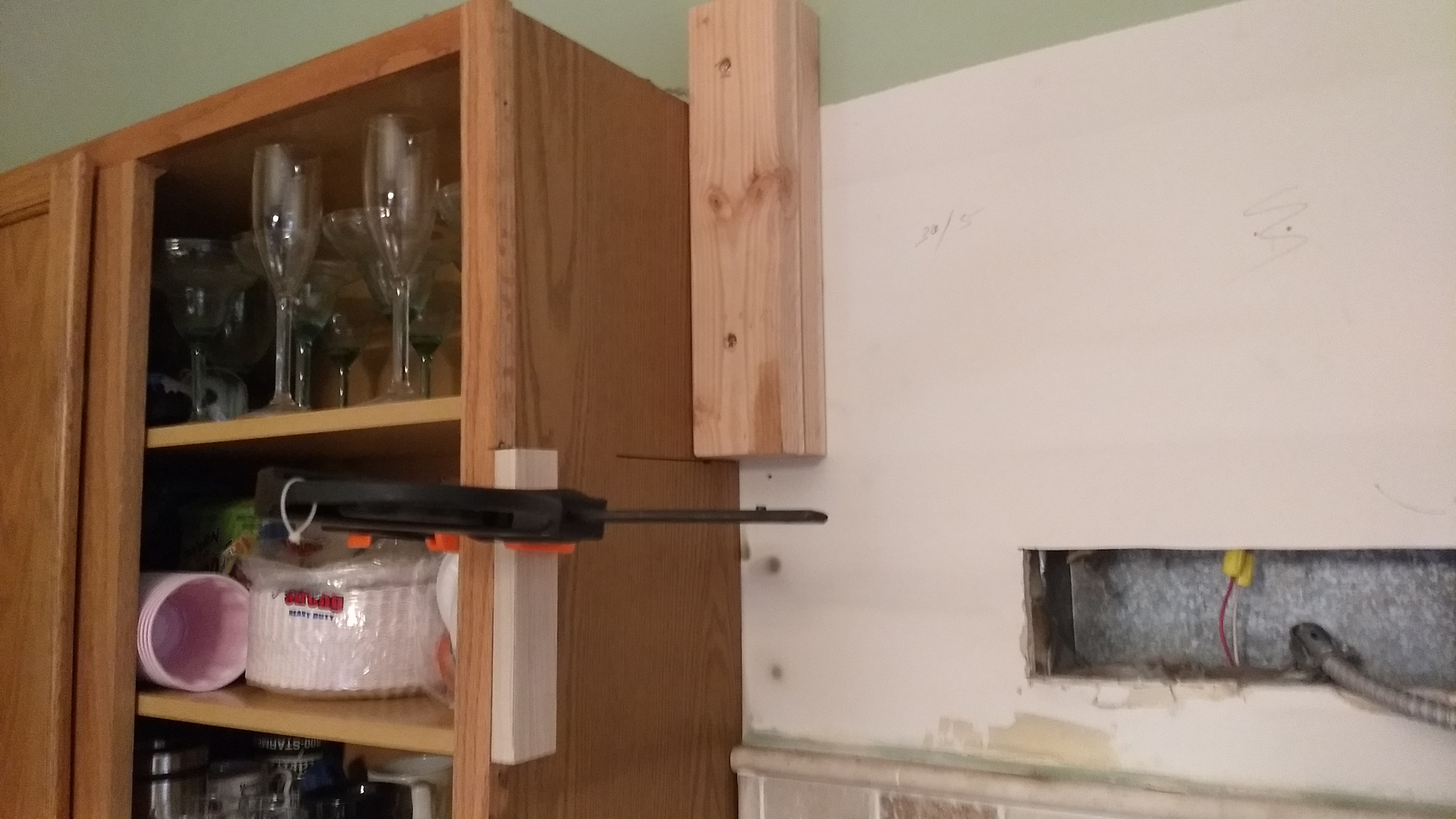 Step 3: Since I am moving the cabinet both up and out, I mounted 3" spacer blocks to the wall studs