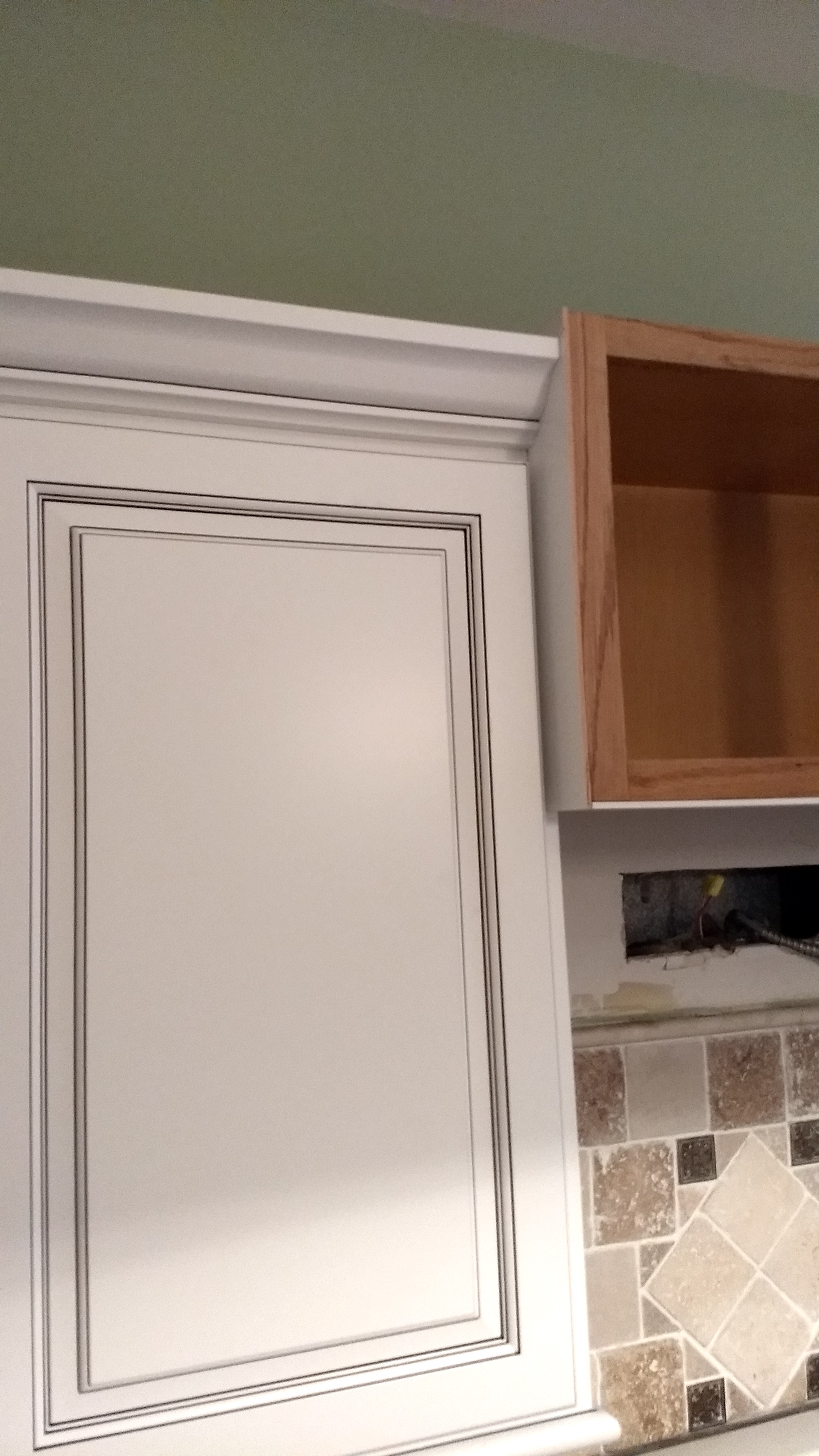 Step 6: You can see I've refaced the cabinet on the side and the new crown molding can end neatly into the side of the center cabinet