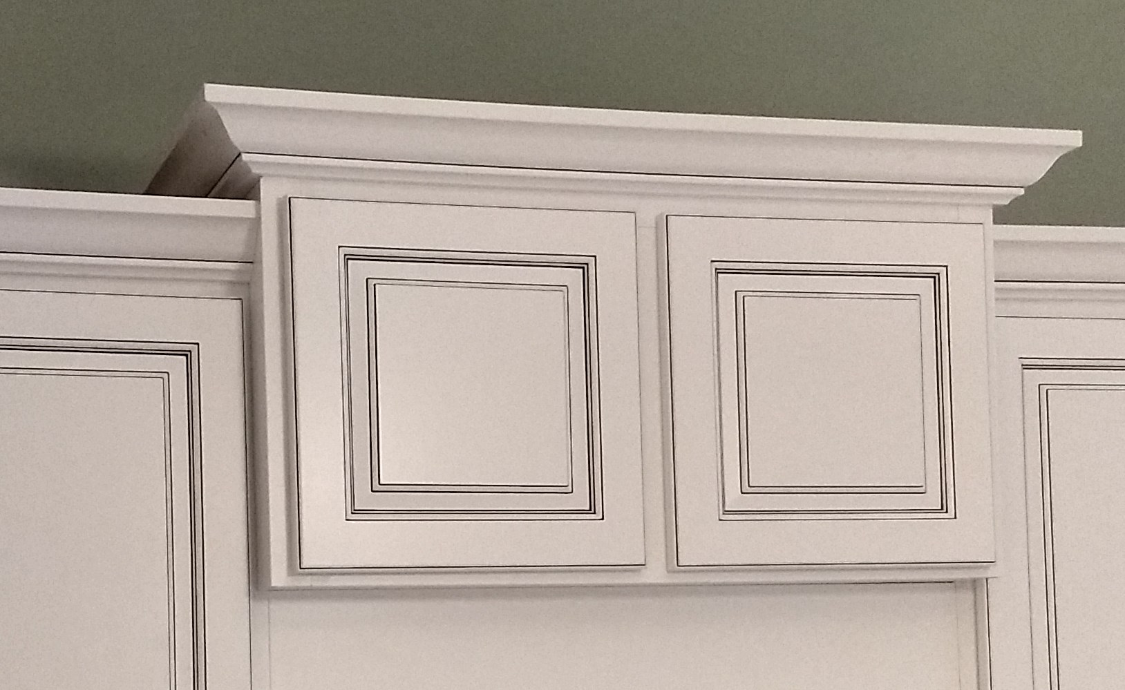 Step 8: The center cabinet has been refaced and the new crown molding wraps around and returns to the wall